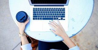 woman reads longitudinal news on laptop