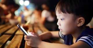 Young boy staring at smartphone