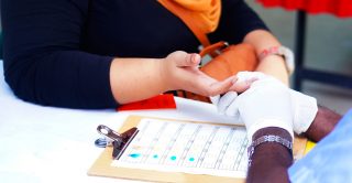 Nurse takes blood sample