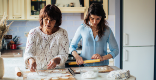 Mother and her teenage daughter baking together