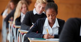 Schoolgirl sits a written exam